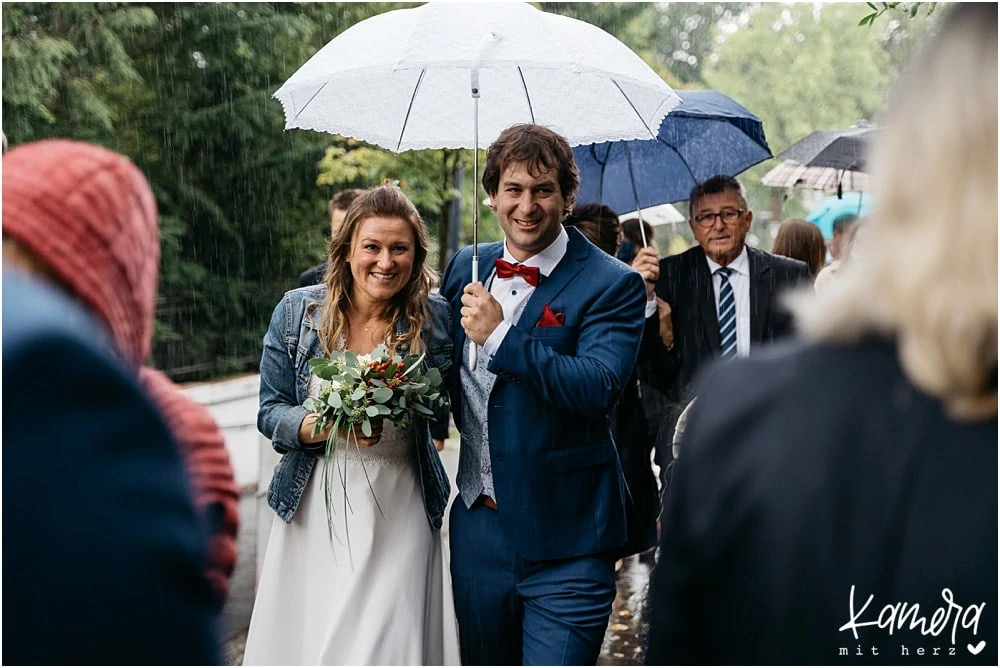 Brautpaar im Regen mit Schirm